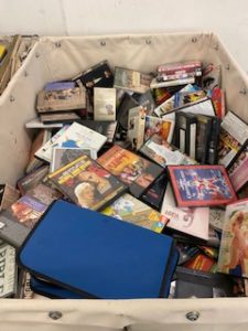 bin containing dvd and cd cases